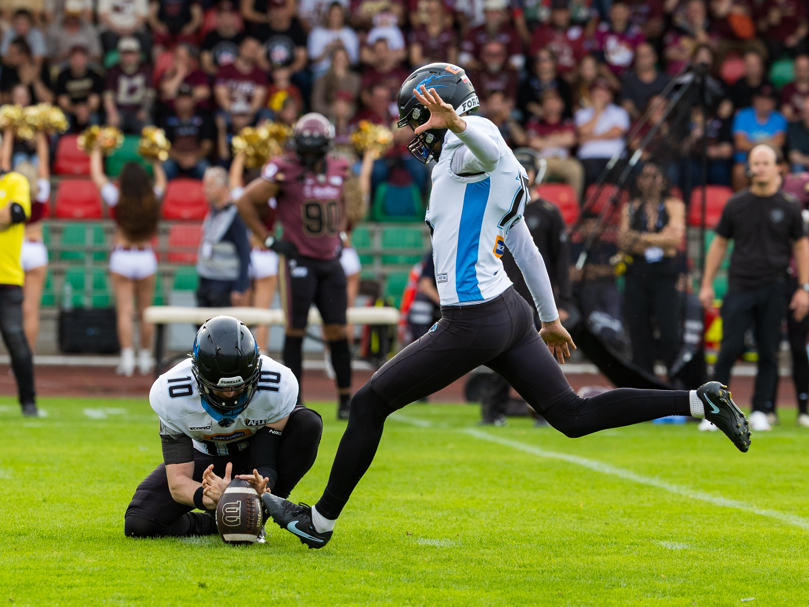 #10 Maciej Krupa (Wide Receiver) – Panthers Wroclaw hold the. Ball for #15 Jakub Ciurkot ( Kicker ) – Panthers Wroclaw