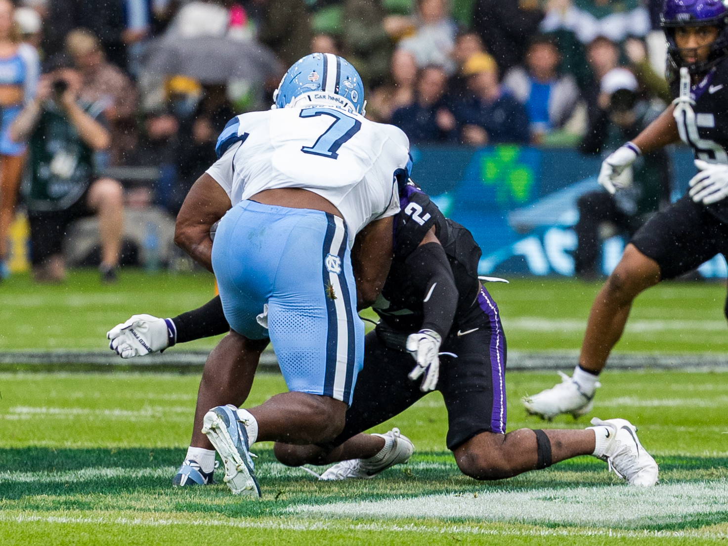 #2 Jamel Johnson (S) TCU Horned Frogs make a low tackle at #7 Benjamin Hall (RB) University of North Carolina Tar Heels