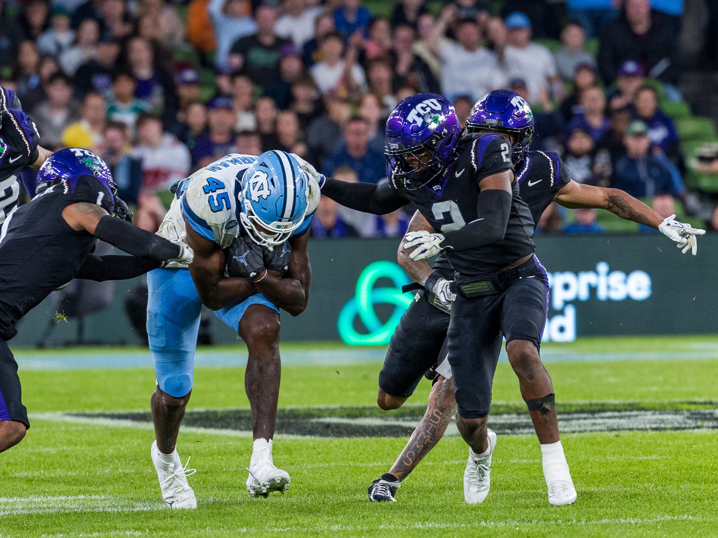 #1 Vernon Glover, Jr. (CB) TCU Horned Frogs and #2 Jamel Johnson (S) TCU Horned Frogs tackle #45 Jelani Thurman (TE) University of North Carolina Tar Heels