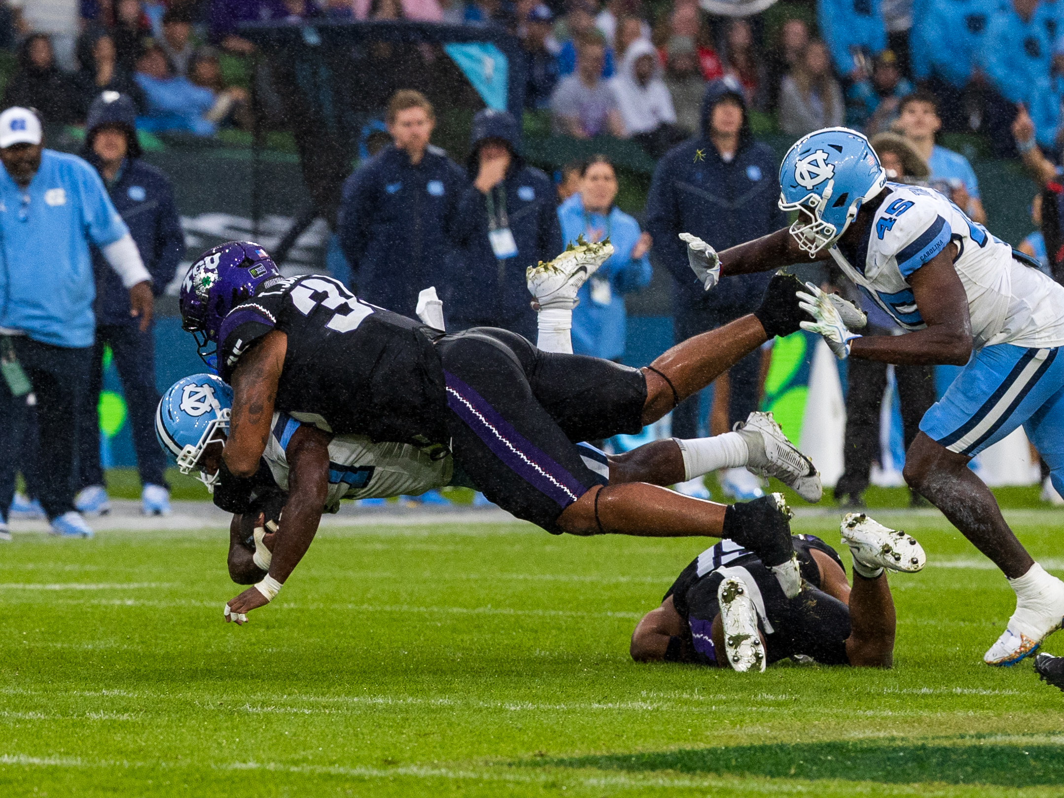 #35 Tristan Johnson (DT) TCU Horned Frogs tackle in the air #7 Benjamin Hall (RB) University of North Carolina Tar Heels