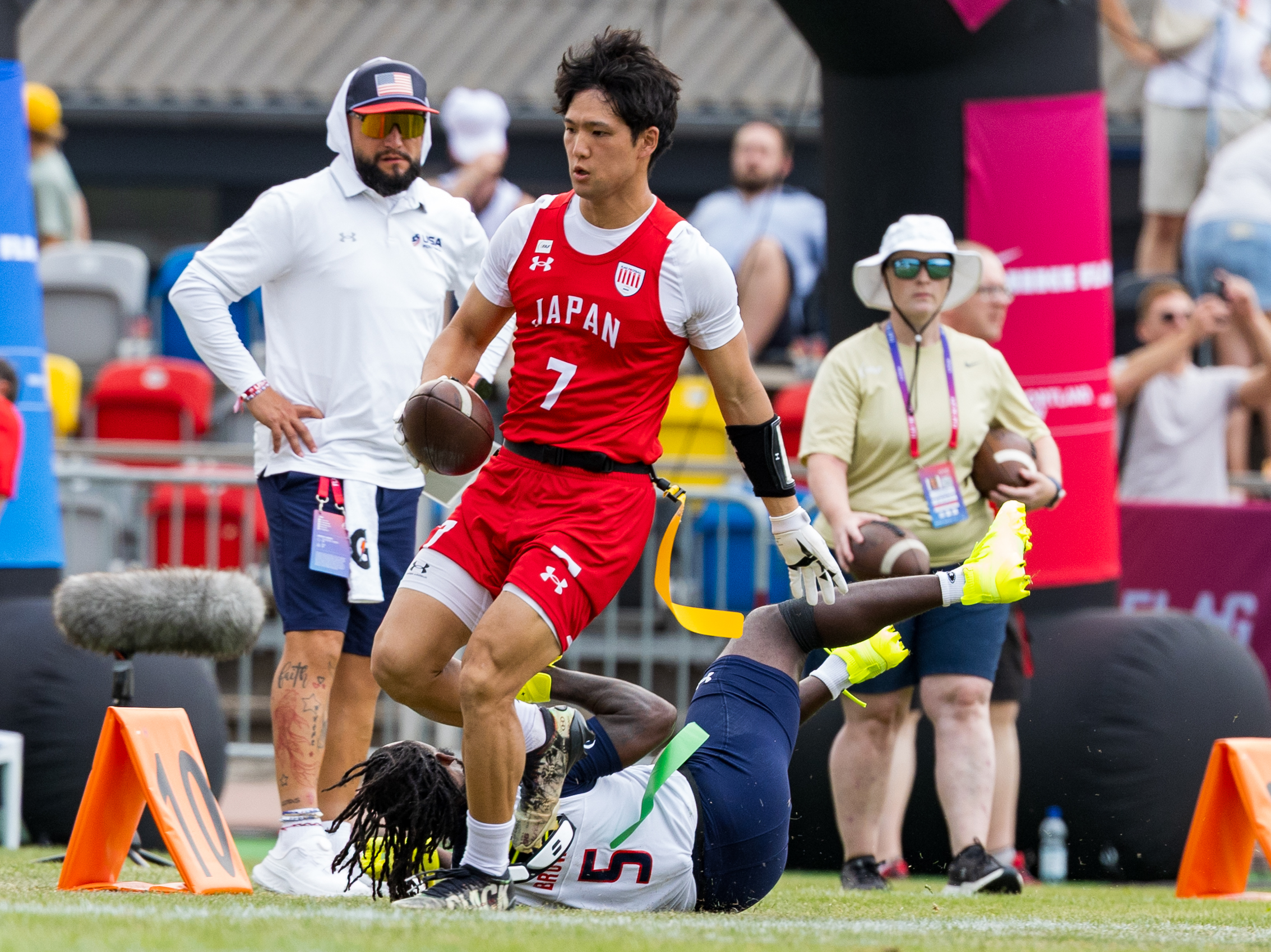 First down #7 HIROKI UCHIDA ( WR/DB ) Team Japan Men. #5 Aamir "Nu" Brown (DB) Team USA Men to late for a tackle.