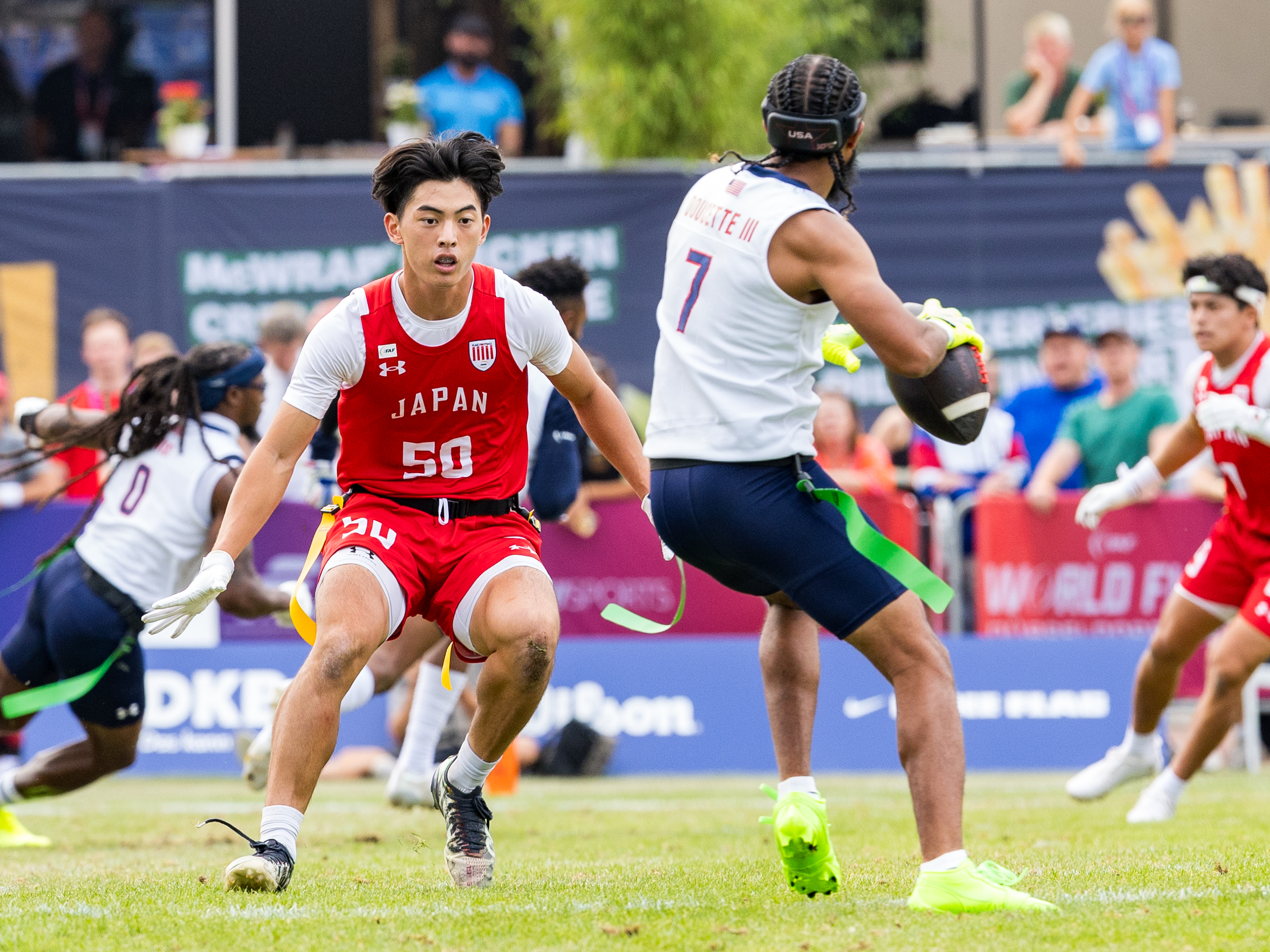 #50 KO KAWASAKI ( DB/WR ) Team Japan Men run to the QB. #7 Darrell "Housh" Doucette III (QB/ATH) Team USA Men pass the ball.