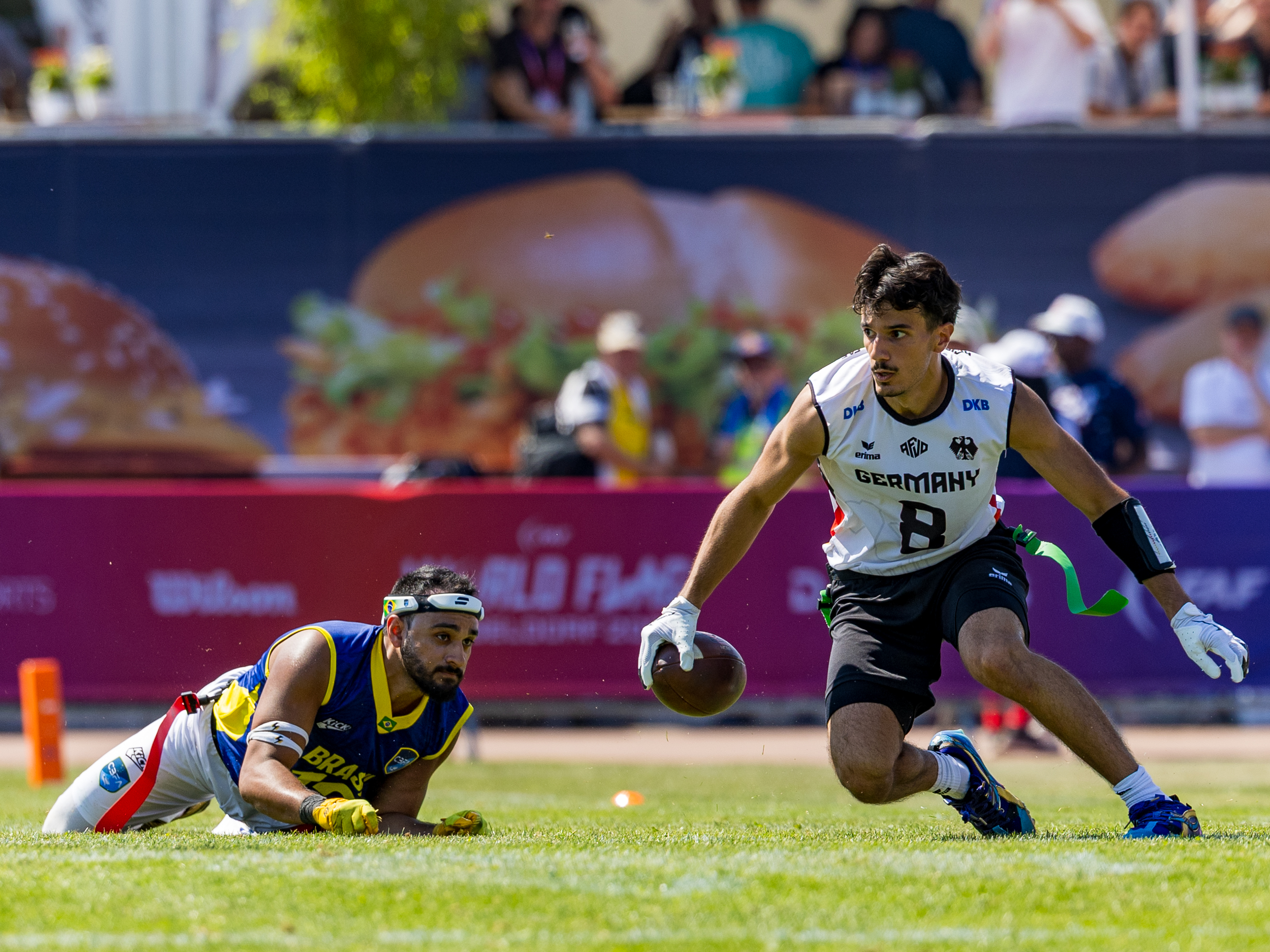 #12 Felipe Nunes Almeida dos Santos (DB) Team Brazil Me to late. #8 Malik Al-Kahlout (WR) Team Germany Men run with the ball.