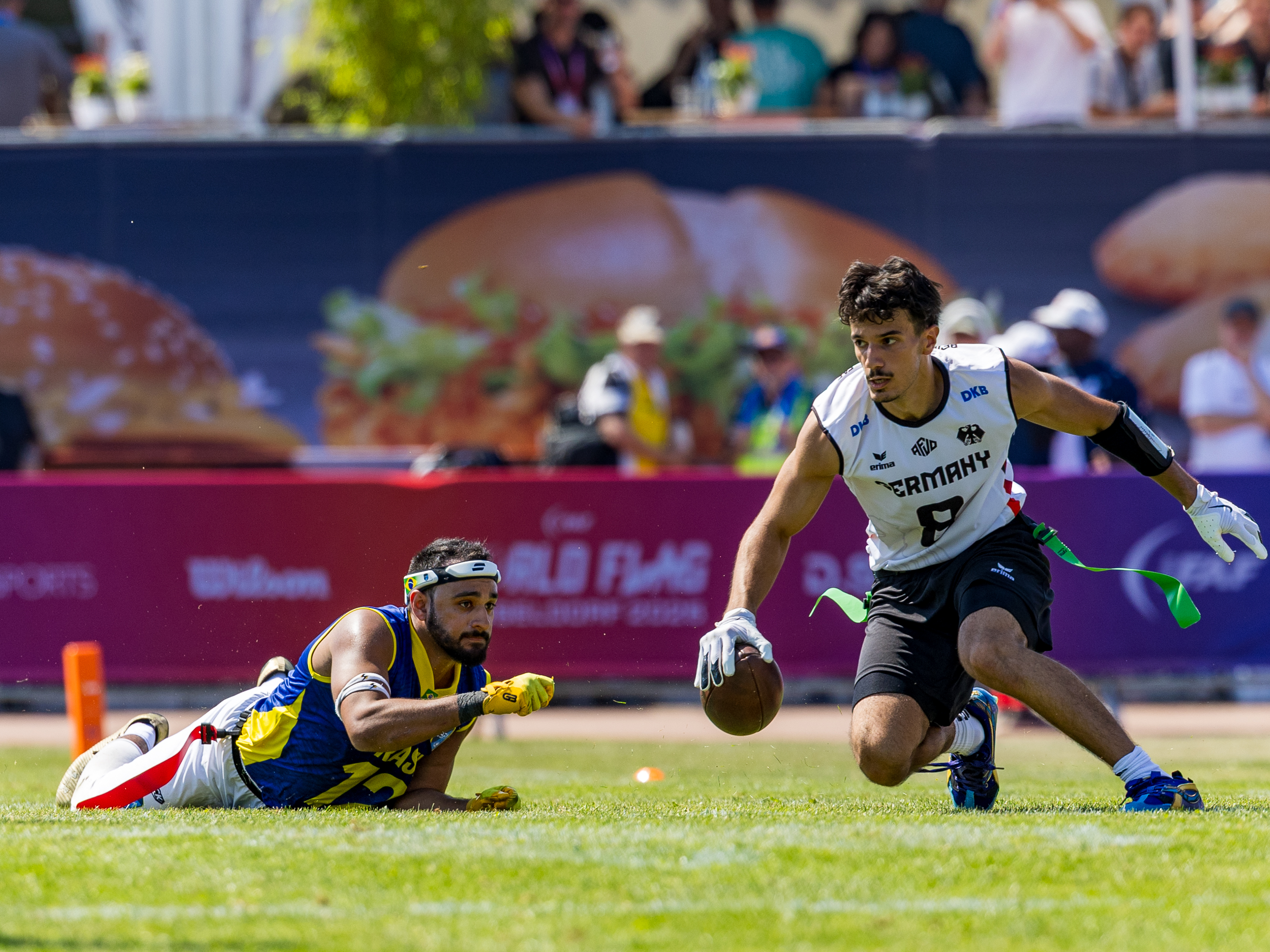 #12 Felipe Nunes Almeida dos Santos (DB) Team Brazil Me to late. #8 Malik Al-Kahlout (WR) Team Germany Men run with the ball.