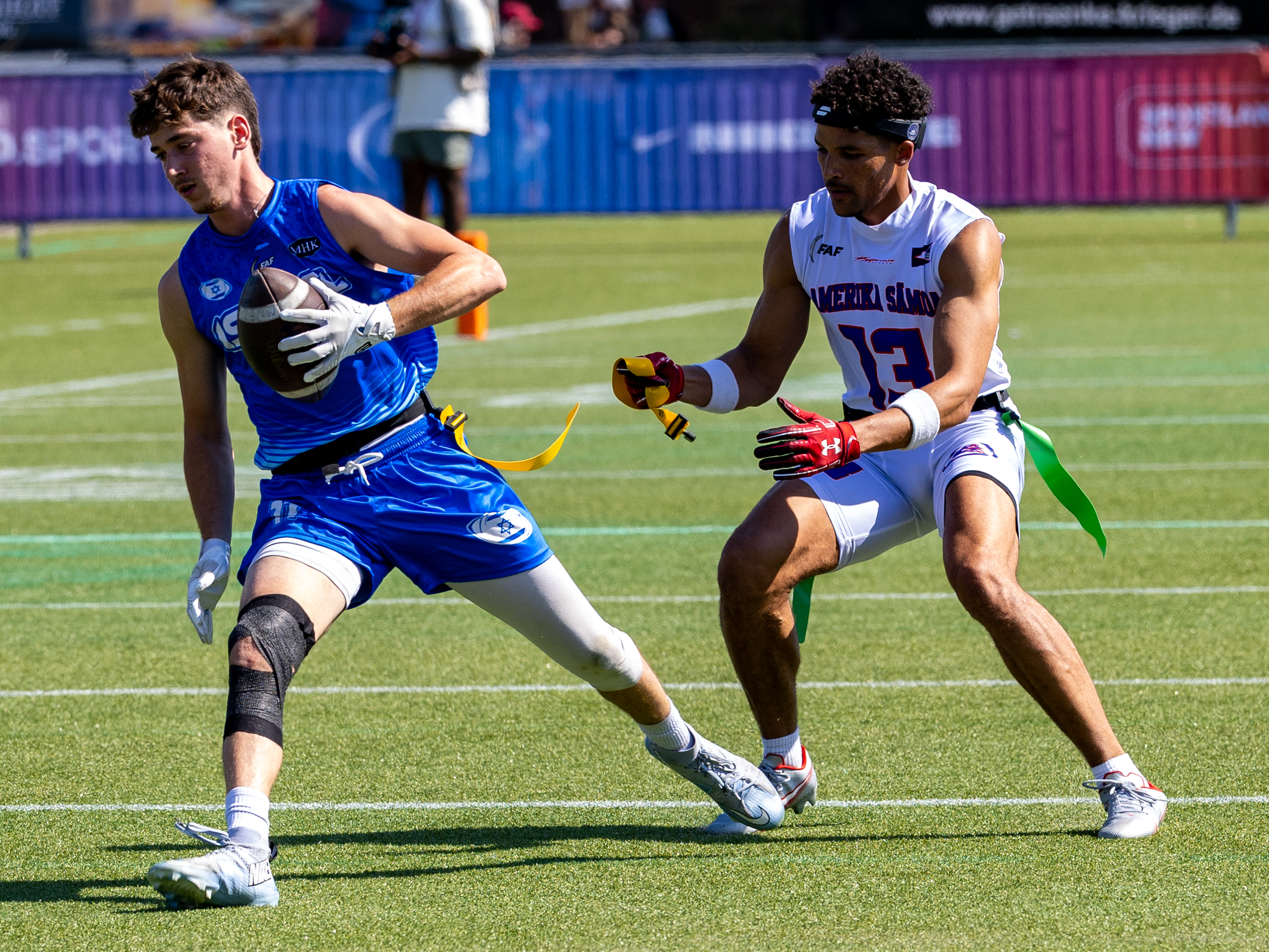 #11 JOSHUA LEVENTHAL (WR) Team Israel Men run with the ball. #13 Alijah Isaiah Holder (WR/DB) Team American Samoa Men catch the flag.