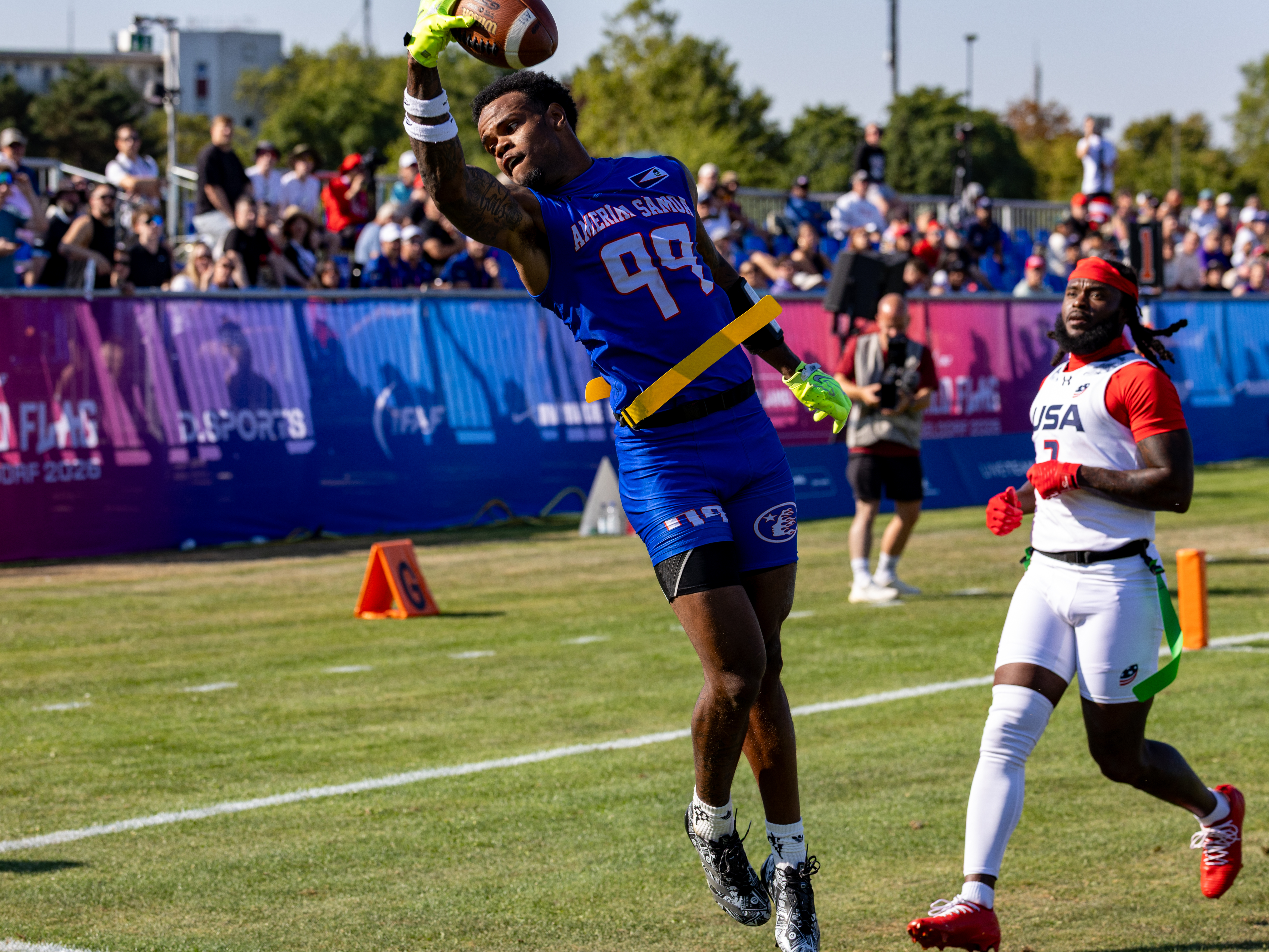 #99 Bralon Brown (WR/DB) Team American Samoa Men catch the ball in the air.
