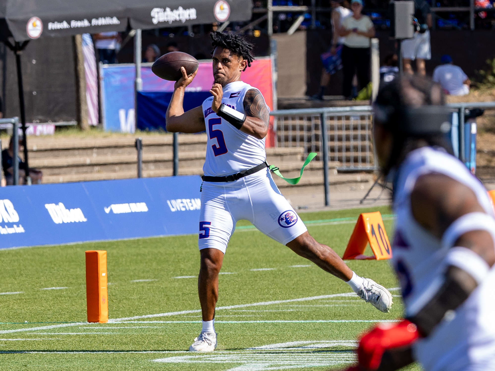 #5 Taulia Tagovailoa (QB) Team American Samoa Men pass the ball to a team player.