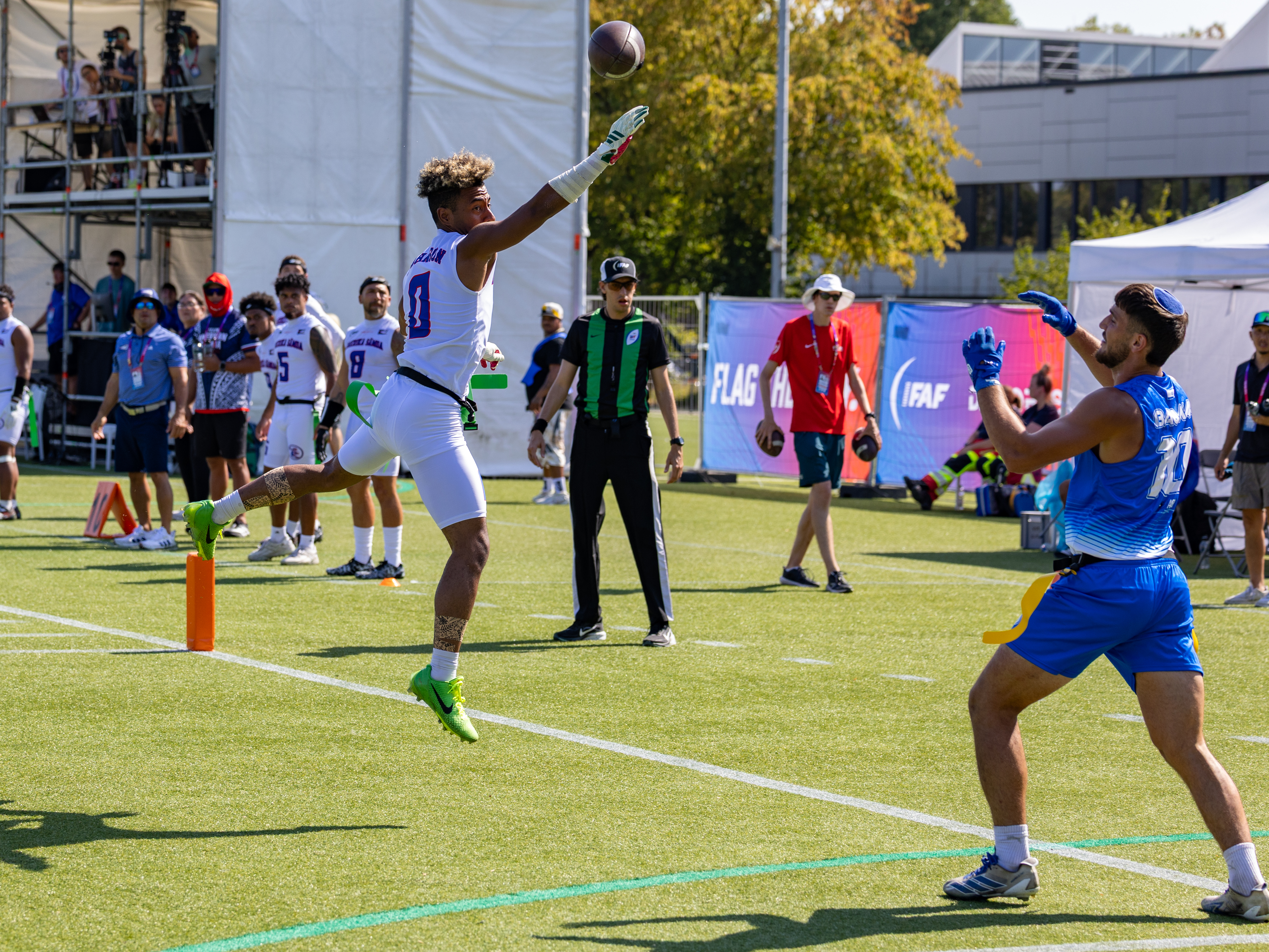 #0 Batchlor Wise Johnson IV (WR/DB) Team American Samoa Men jump high to catch the ball. #10 MATAN BAUMAN (WR) Team Israel Men wait for the catch