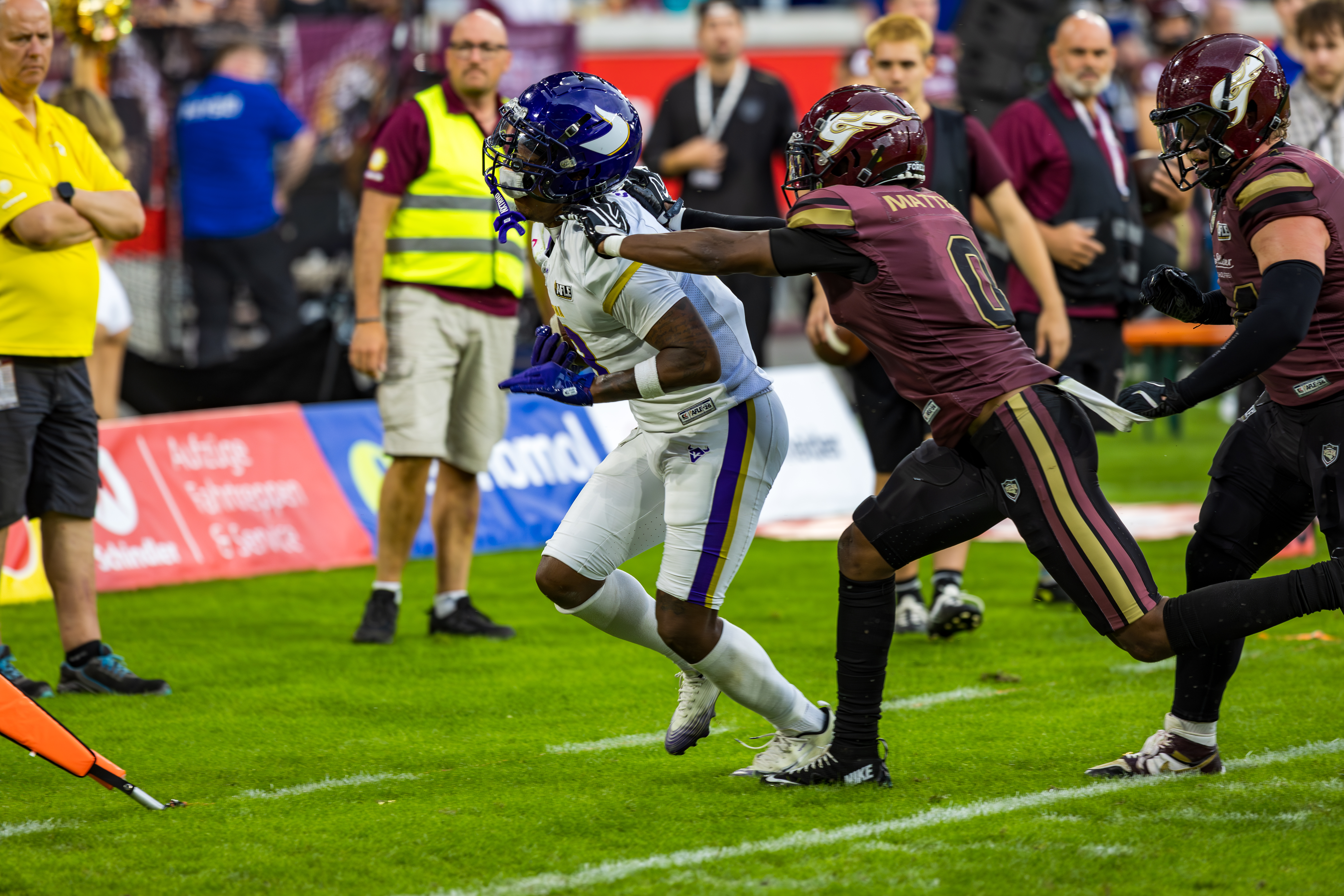 #0 Christian Matthew (Defensive Back) – Rhein Fire tackle #8 Darrell Stewart (Wide Receiver) – Vienna Vikings out the field.