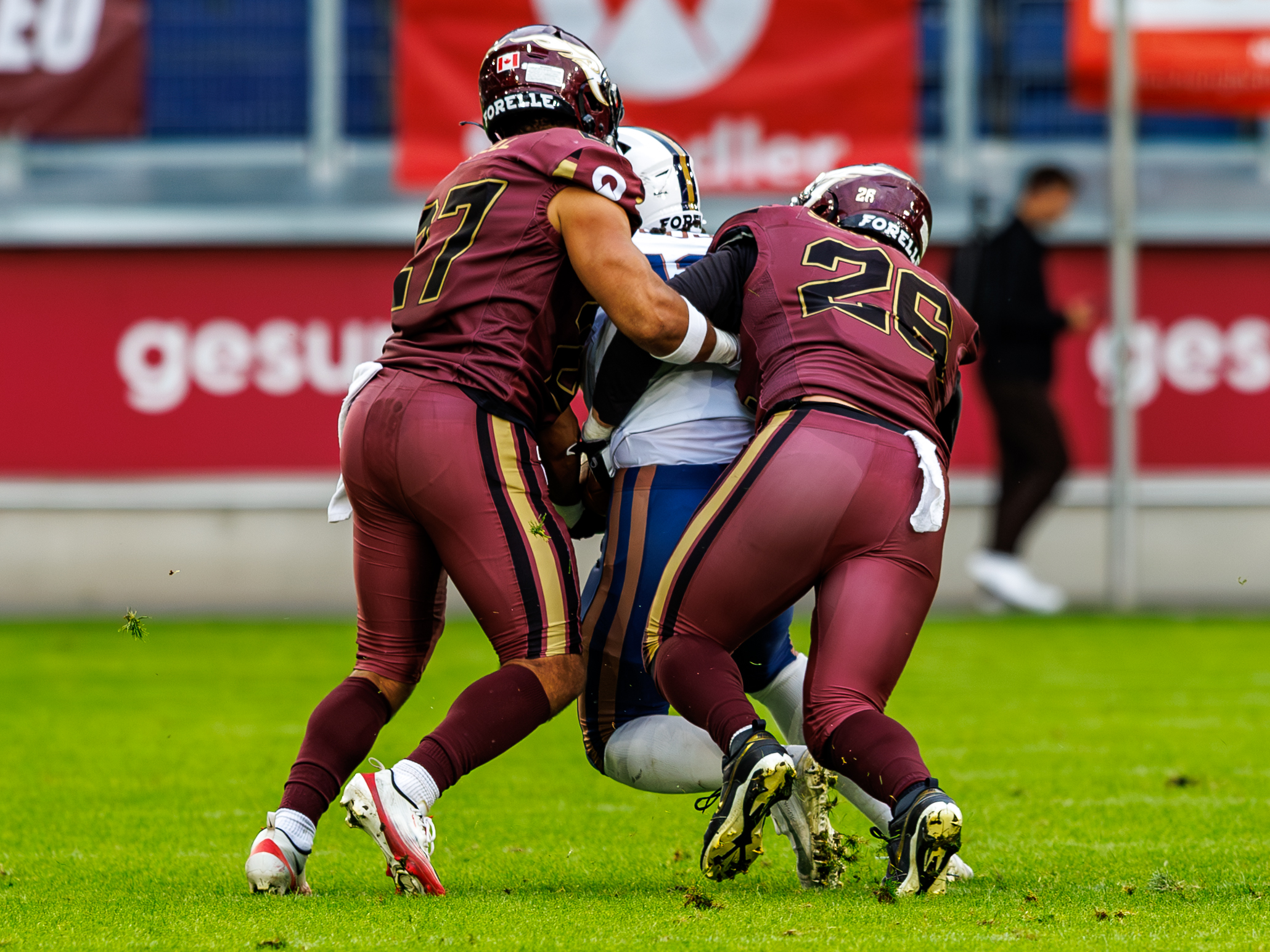 #26 Lino Schröter (Linebacker) – Rhein Fire and #27 Justin Howell (Defensive Back) – Rhein Fire tackle #13 Florian Larose (Wide Receiver) – Paris Lights