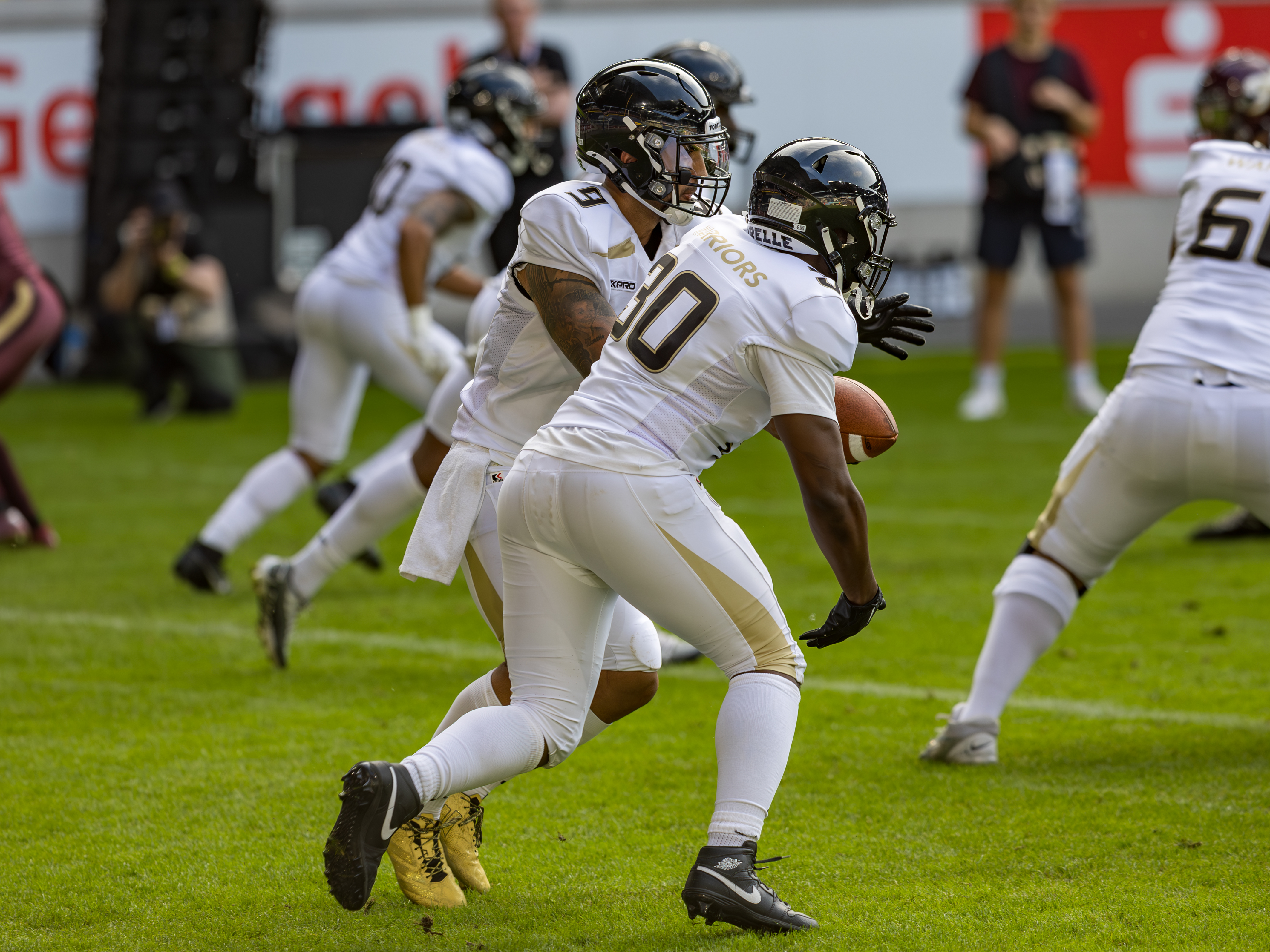 #9 Karé Lyles (Quarterback) – London Warriors passes the ball to #30 Uriah Higgins (Running Back) – London Warriorsi
