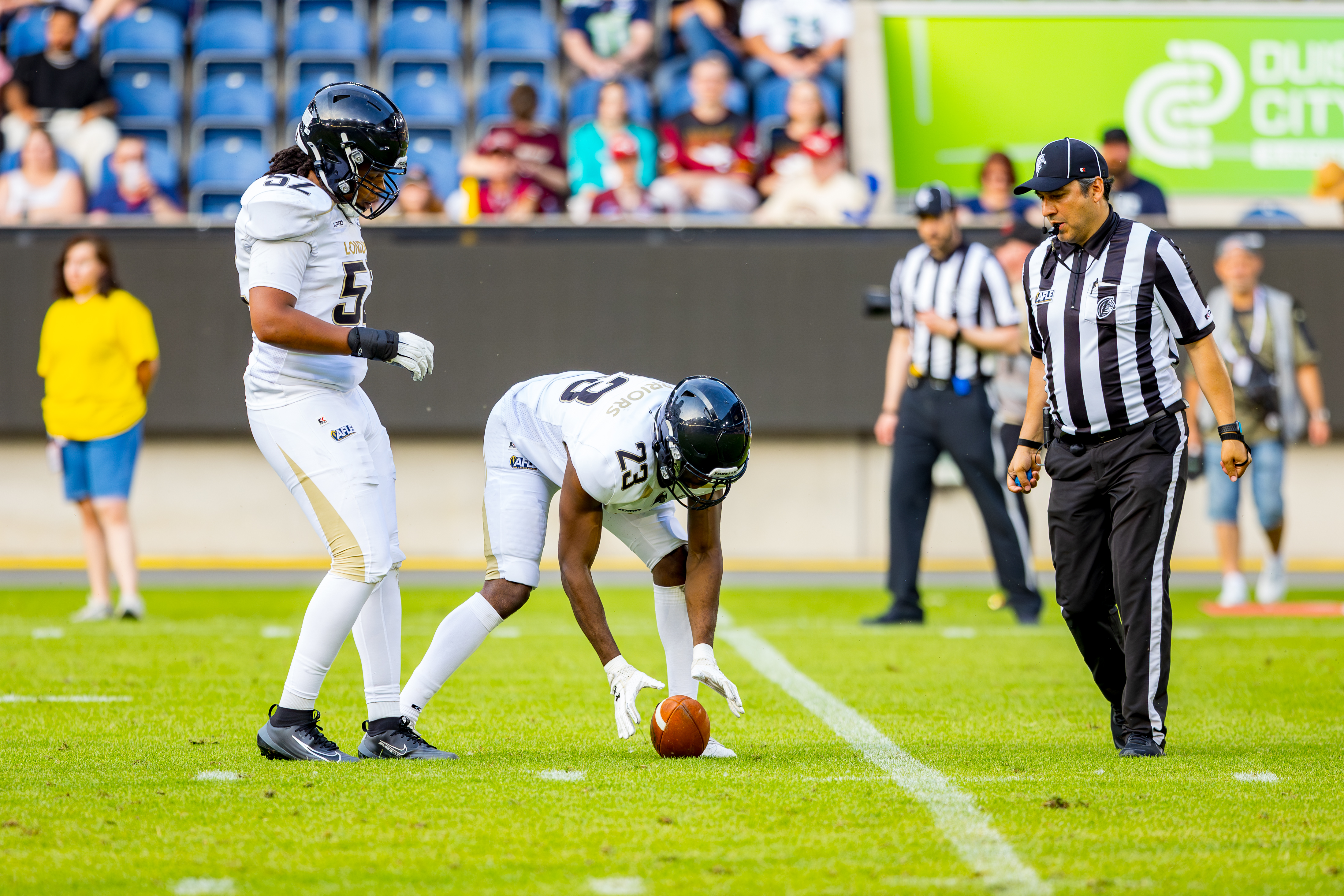 #52 Deandre Silcott (Defensive Line) – London Warriors and #23 Ayo Kabia (Defensive Back) – London Warriors touch the ball.