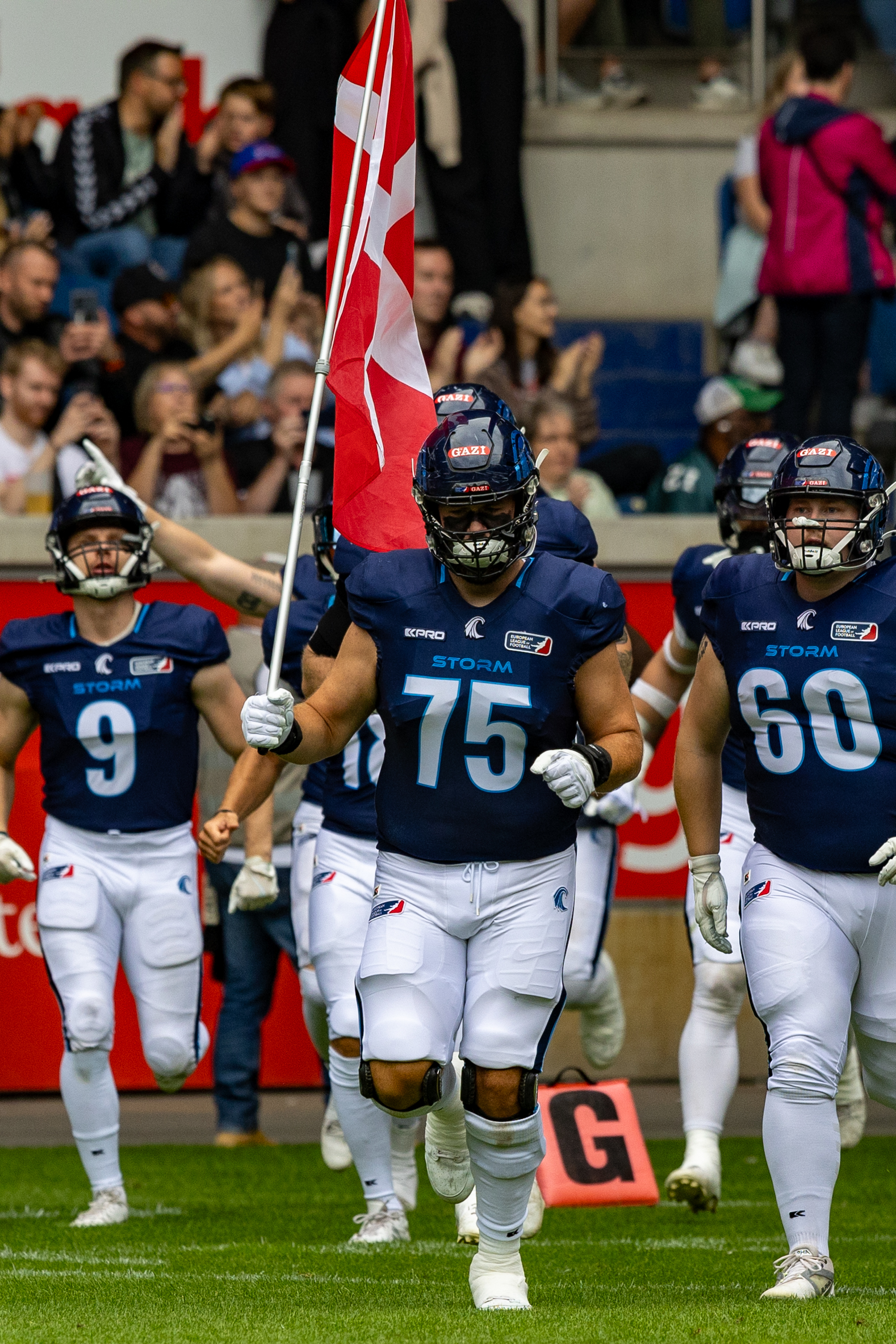 #75 Joachim Christensen (C) Nordic Storm with flag. Rhein Fire vs Nordic Storm, American Football, European League of Football, Week 14, 2025, 17.08.2025,