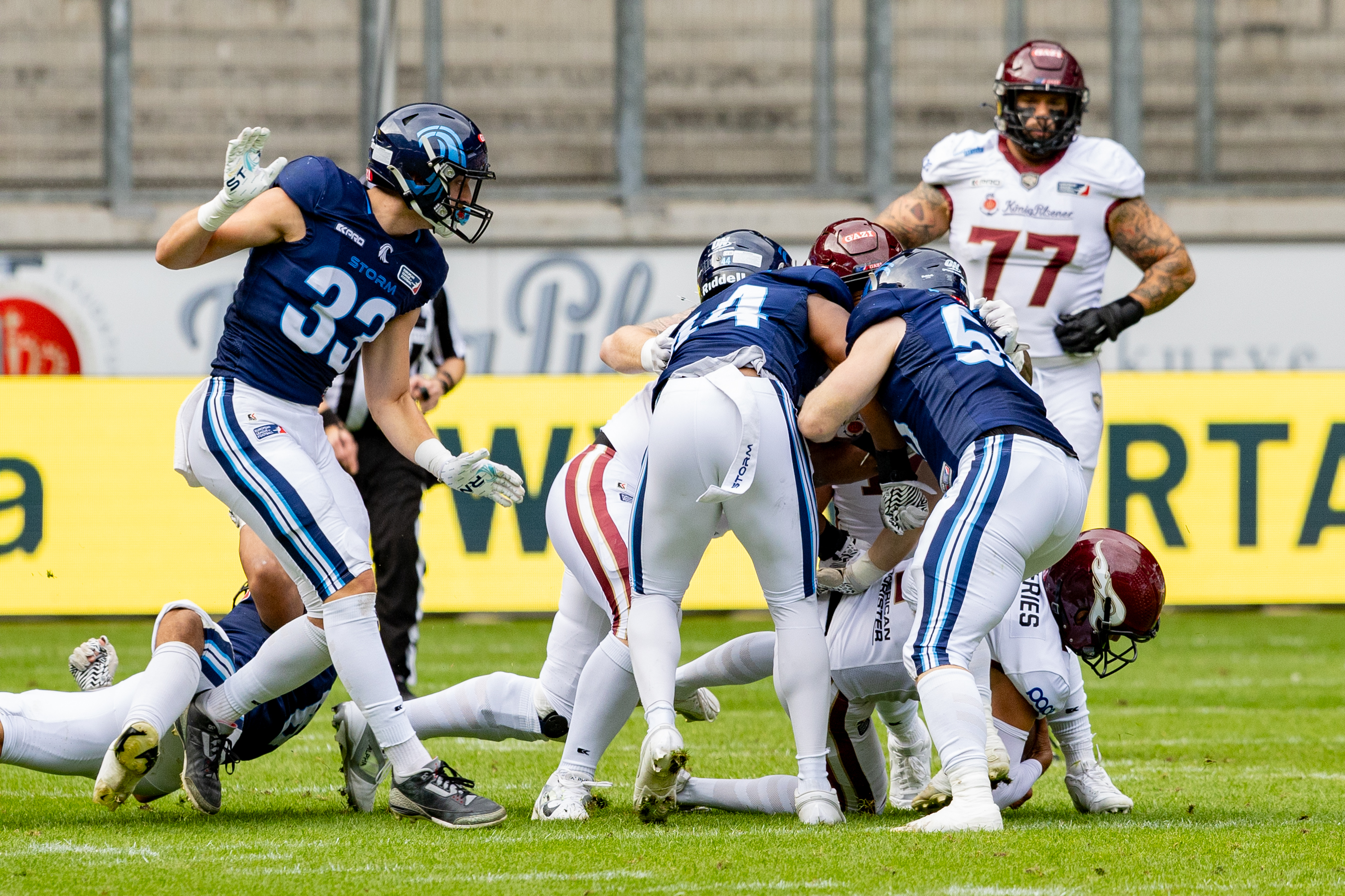 #33 Elliot Krogius (CB) Nordic Storm, #44 Emmanuelle Falola (LB) Nordic Storm and #55 Hugo Dyrendahl (LB) Nordic Storm tackle #11 Jonathan Scott (RB) Rhein Fire . Rhein Fire vs Nordic Storm, American Football, European League of Football, Week 14, 2025, 17.08.2025,
